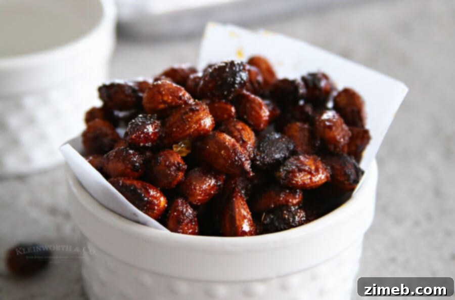 Close-up of crispy Sriracha Spice Almonds in a white bowl, ready for snacking.