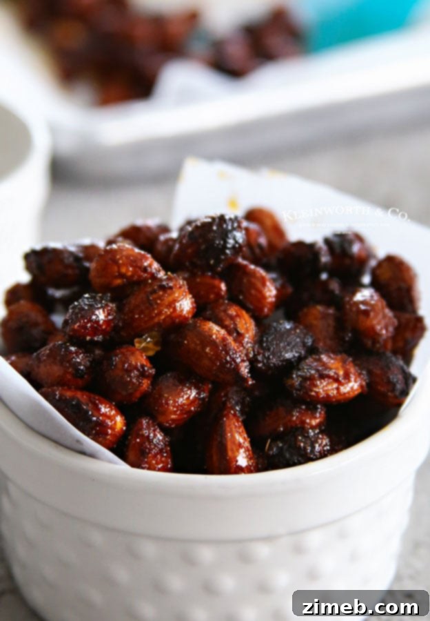 A bowl overflowing with freshly made Sriracha Spice Almonds, showing their rich, toasted texture.