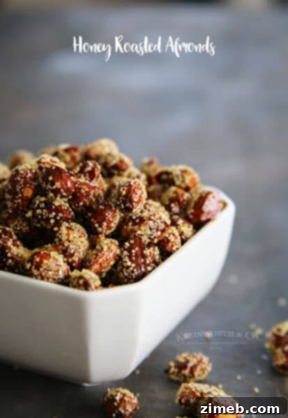 A charming wooden bowl filled with golden Honey Roasted Almonds.