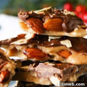 A close-up of broken pieces of glistening Traditional Almond English Toffee.