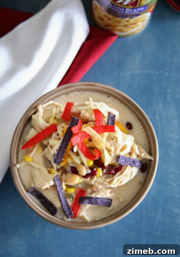 Close-up of creamy Slow Cooker White Chicken Chili with beans and chicken