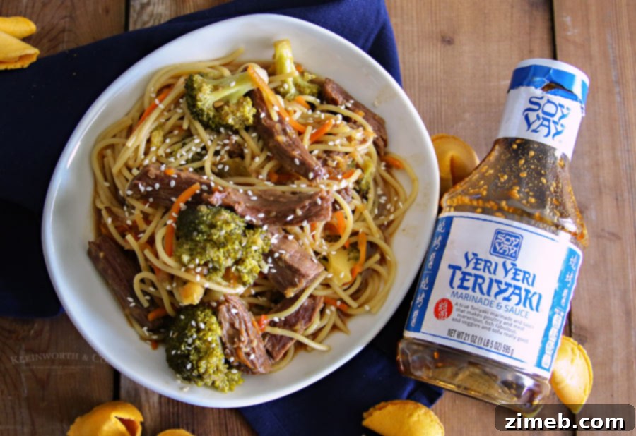 Slow Cooker Beef Teriyaki Lo Mein with chopsticks, ready to eat.