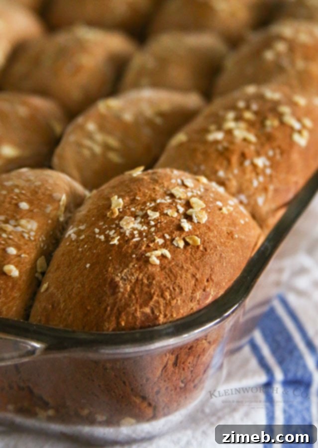 Freshly baked One Hour Brown Bread Dinner Rolls cooling on a wire rack.