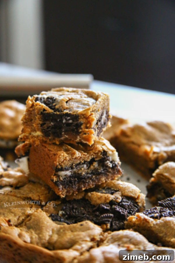 Oreo Peanut Butter Blondie Delights 2 Close-up of freshly baked Oreo Stuffed Peanut Butter Blondies, showing the gooey peanut butter blondie and chunks of Oreo cookies.