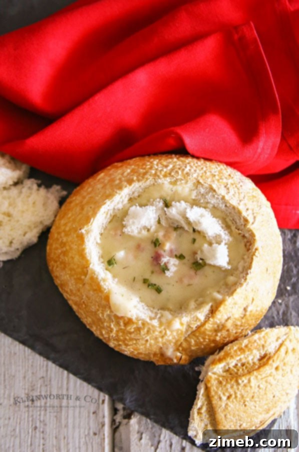 Close-up of a steaming Disney-inspired clam chowder bread bowl, ready to be enjoyed.