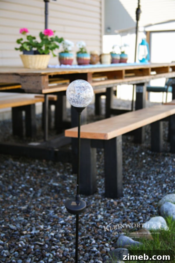 Close-up of Spring Outdoor Pallet Table Decor with flowers and settings.