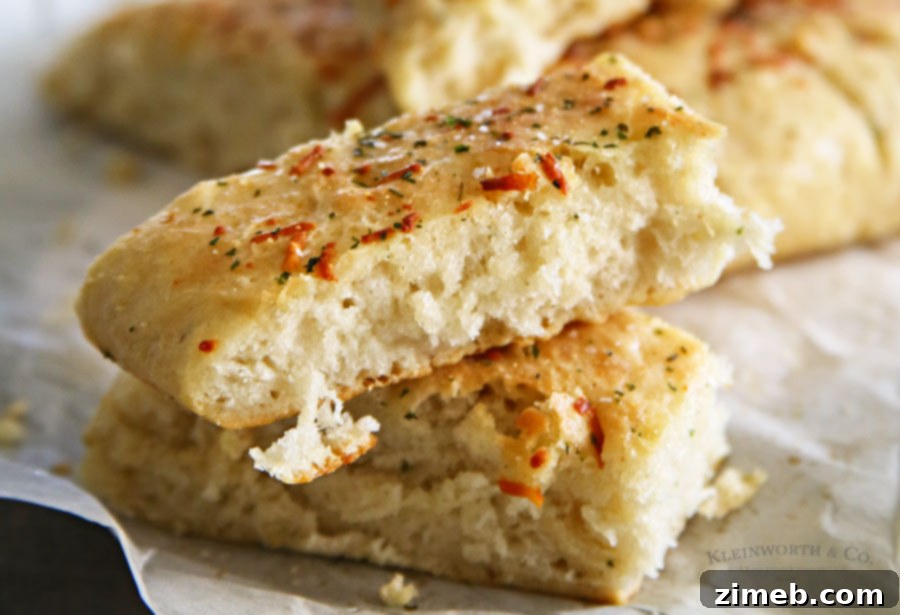 A tray of rising Easy Garlic Parmesan Breadsticks dough, showing the texture before baking.