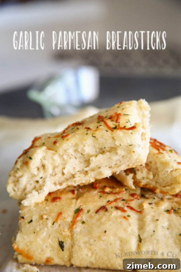 A plate of golden, buttery Easy Garlic Parmesan Breadsticks, ready to serve.