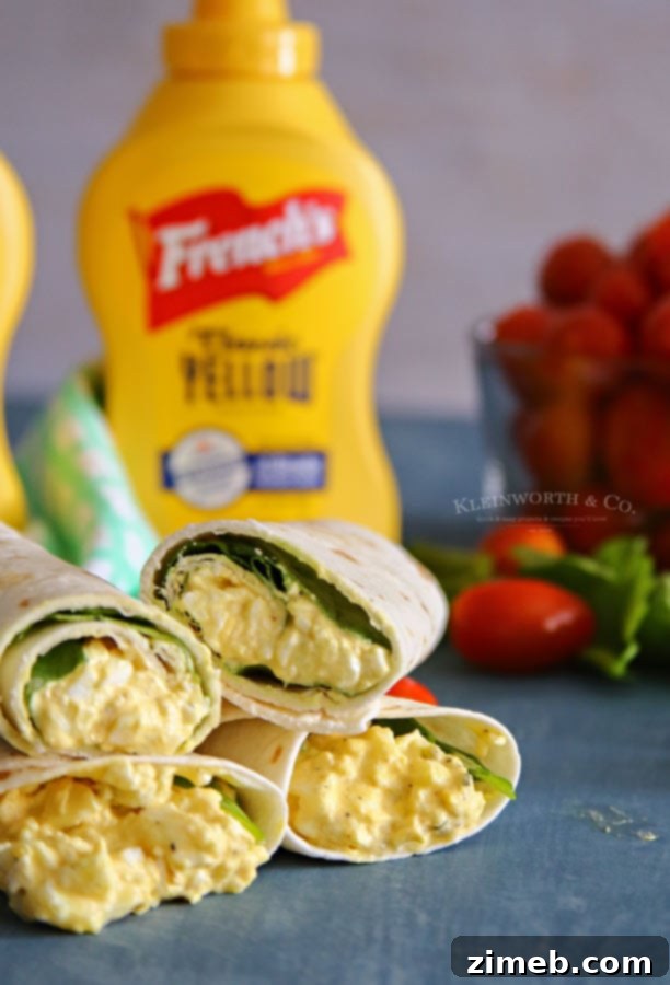Garden Fresh Egg Salad Wraps 6 A stack of two halved Egg Salad Spinach Wraps, revealing the delicious filling and layered spinach inside
