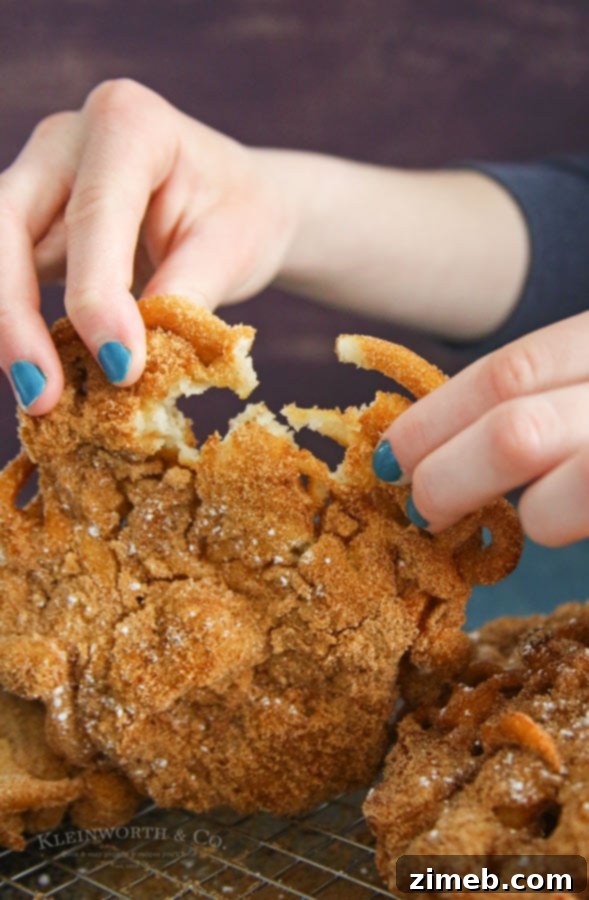 Churro Funnel Cake Made Simple 4 A stack of golden brown Easy Churro Funnel Cakes, ready to be coated