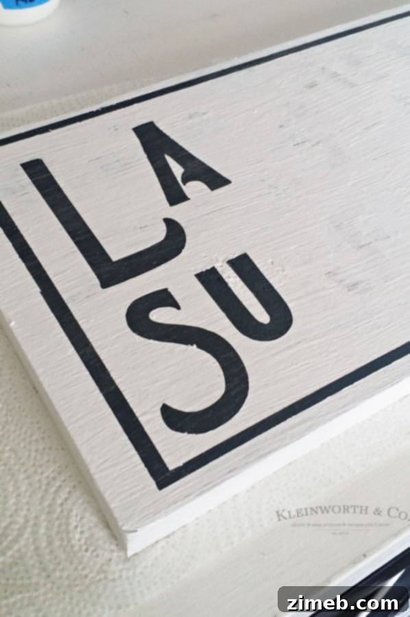 Peeling Off the Cricut Stencil to Reveal Your Custom Surfer Sign