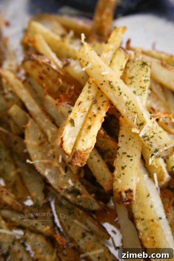Ultimate Garlic Parmesan Baked Steak Fries 4 A serving of freshly baked Garlic Parmesan Steak Fries, seasoned to perfection and ready to be enjoyed.