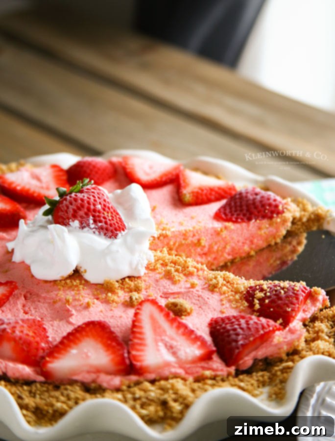 Dreamy No-Bake Strawberry Banana Cheesecake 5 A completed No Bake Strawberry Banana Cheesecake, garnished with fresh strawberries and ready to serve.
