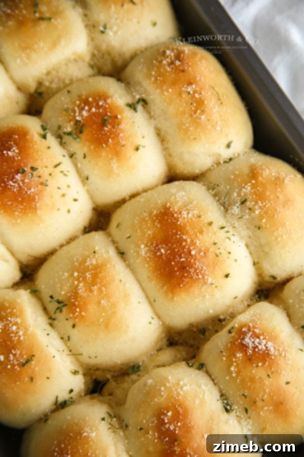 Garlic Parmesan Dinner Rolls in 30 Minutes 2 A batch of golden 30-Minute Dinner Rolls cooling on a wire rack.