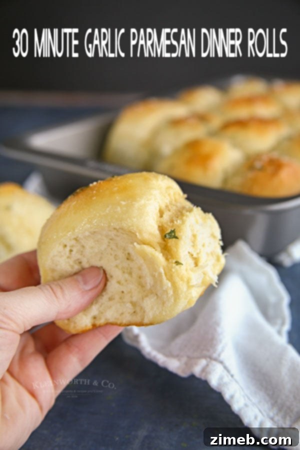 Garlic Parmesan Dinner Rolls in 30 Minutes 17 A basket full of warm 30-Minute Garlic Parmesan Dinner Rolls, ready to be served.