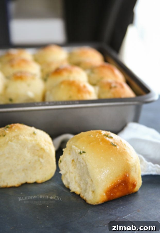 Garlic Parmesan Dinner Rolls in 30 Minutes 4 Freshly baked 30-Minute Garlic Parmesan Dinner Rolls arranged for a holiday meal.