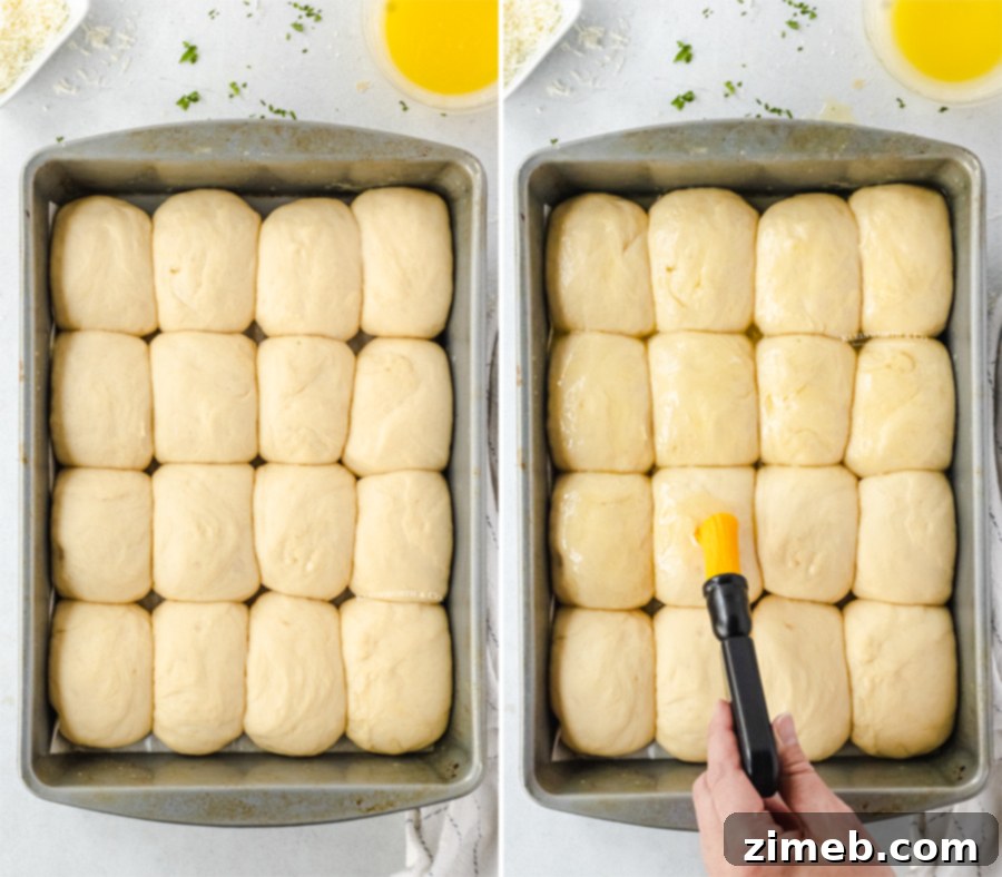 Garlic Parmesan Dinner Rolls in 30 Minutes 8 Brushing melted butter onto dinner rolls before baking to ensure a golden crust.