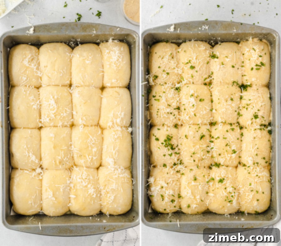 Garlic Parmesan Dinner Rolls in 30 Minutes 9 A close-up of dinner rolls being topped with garlic, herbs, and Parmesan cheese before baking.