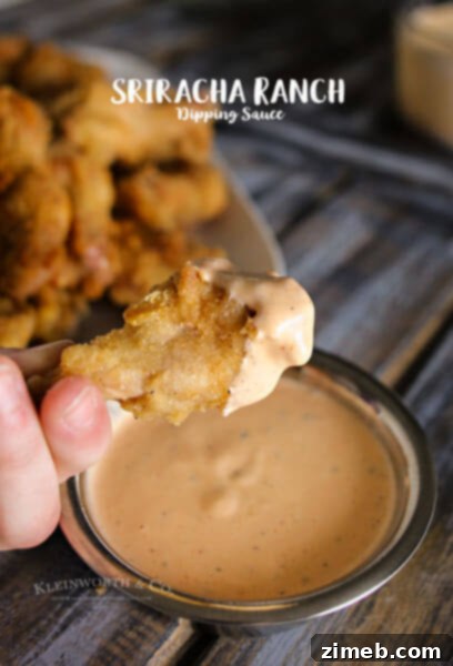 Sriracha Ranch Dipping Sauce in a bowl with crudites, a spicy and creamy condiment