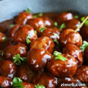 Close-up of Kicky BBQ Ale Meatballs in a bowl, garnished with fresh parsley