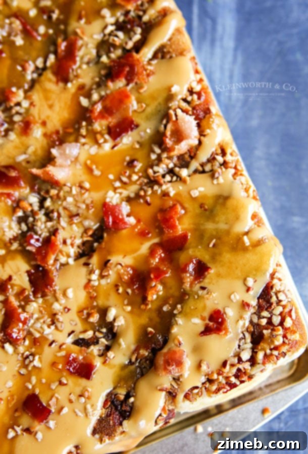 Sweet and Salty Bacon Caramel Sticky Buns 2 Close-up of golden brown Bacon Caramel Sticky Buns with gooey caramel and bacon crumbles.