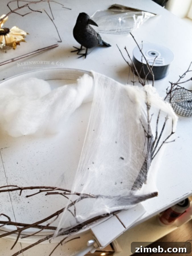 Spooky Raven Halloween Wreath - stretch spiderwebs on branches