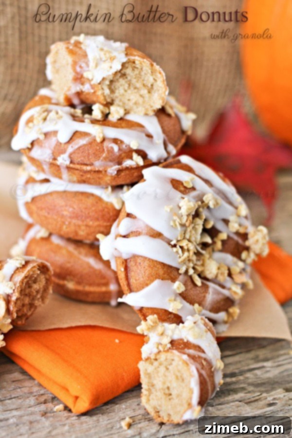 Decadent Pumpkin Butter Donuts topped with a sweet glaze and sprinkles.