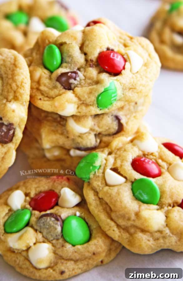 A festive pile of Santa's Favorite Chocolate Chip Cookies featuring vibrant red and green M&Ms.