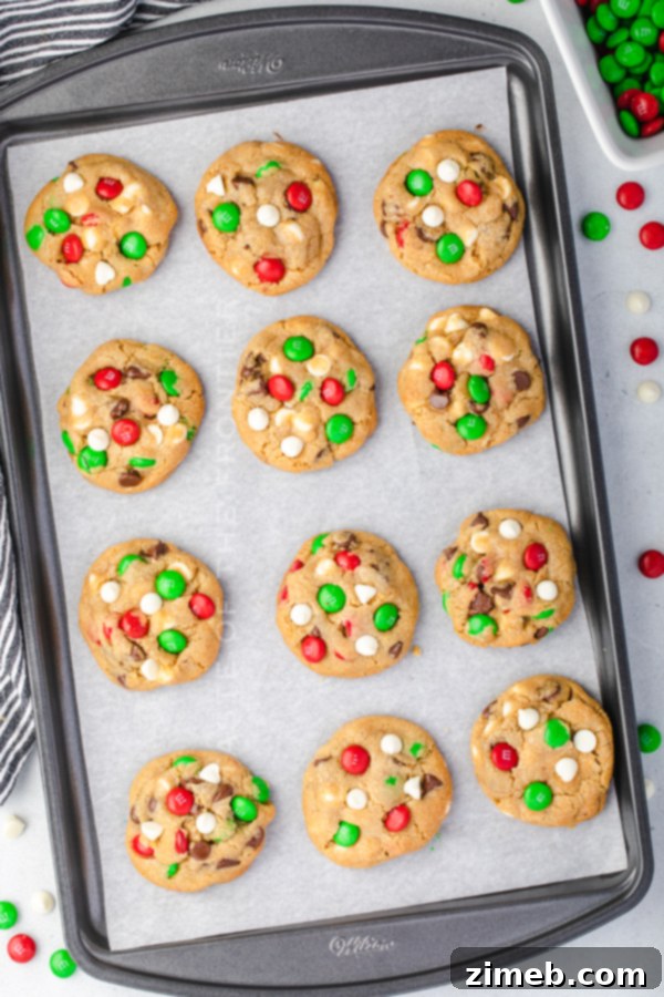 A stack of freshly baked Santa's Favorite Chocolate Chip Cookies, garnished with M&Ms, ready for enjoyment.