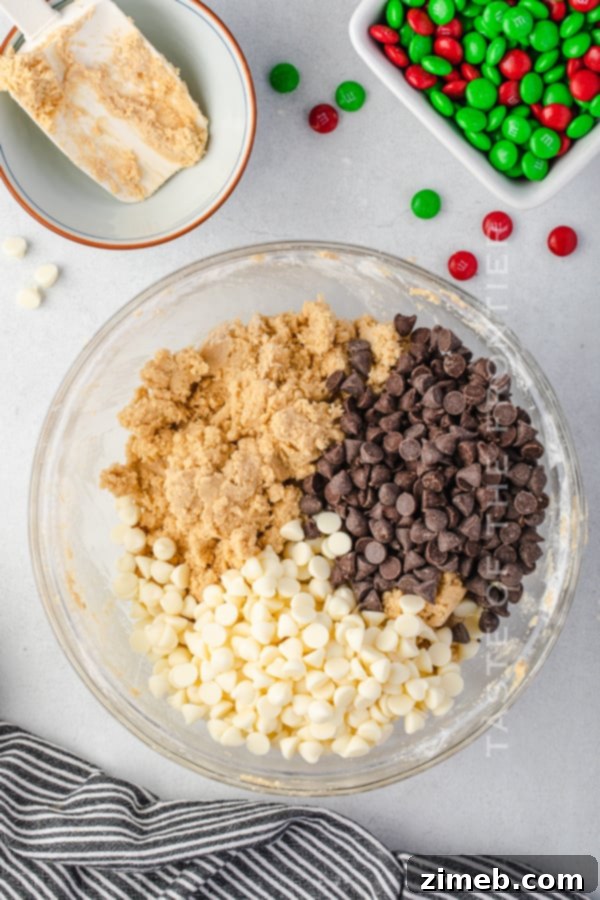Close-up of cookie dough being mixed in a bowl with a stand mixer, showcasing its rich, creamy texture.