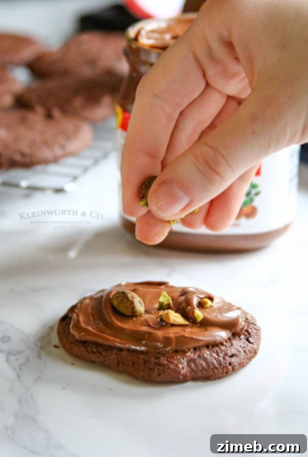 Festive chocolate holiday cookies generously topped with creamy Nutella.