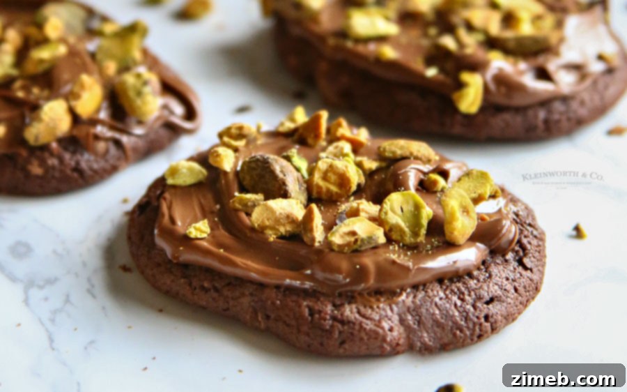 Recipe for chocolate Nutella pistachio cookies, featuring a platter of finished treats.
