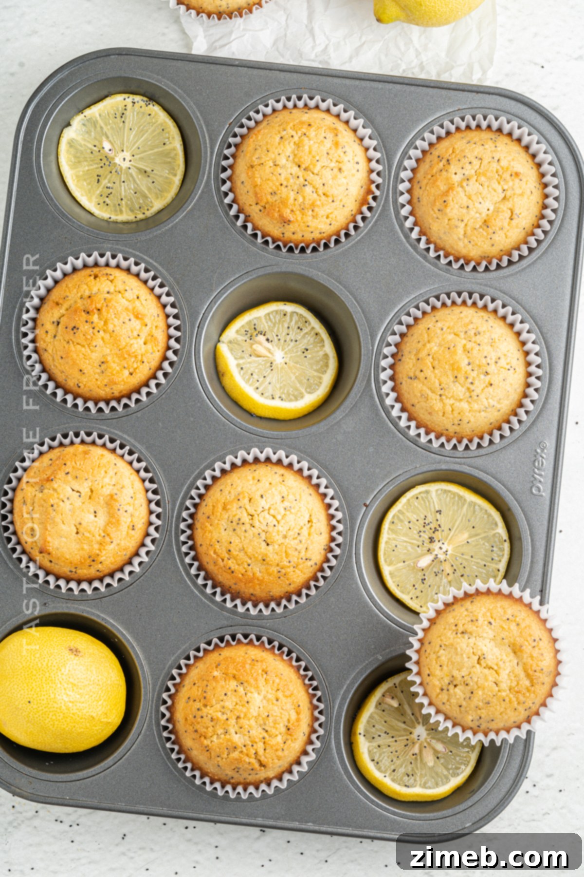 Sunshine Lemon Poppy Seed Muffins 7 Perfectly baked Lemon Poppy Seed Muffins cooling on a rack