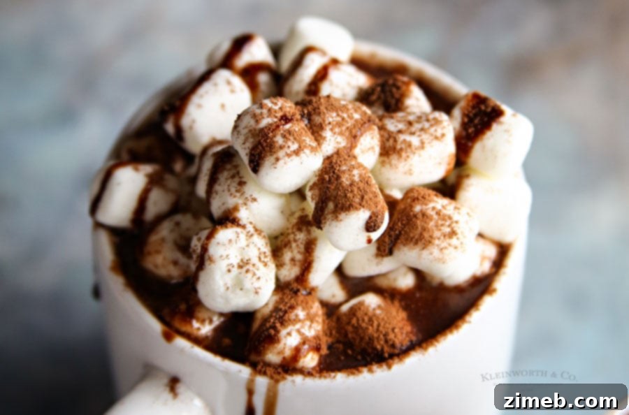 A large pot of Peanut Butter Cup Slow Cooker Hot Chocolate, ready to be served into mugs.