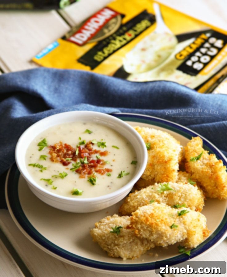 Golden Crispy Chicken Tenders with Hearty Potato Soup 5 A close-up shot of perfectly golden and crispy chicken tenders, ready to be enjoyed.