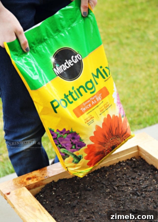Build a Wheeled Garden Box 12 Filling Your DIY Rolling Planter Box with Miracle-Gro Potting Mix