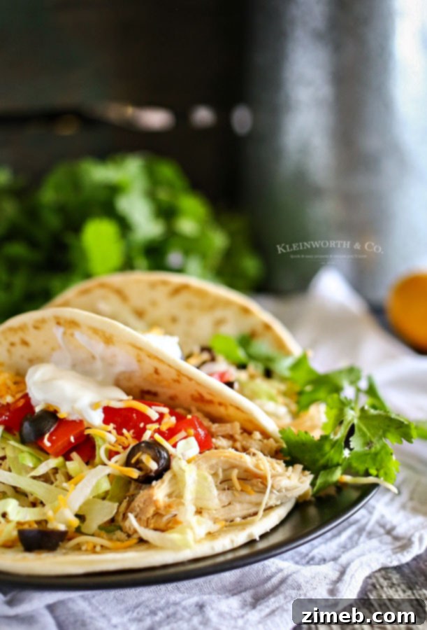 Delicious fiesta chicken tacos made with slow cooker pulled chicken