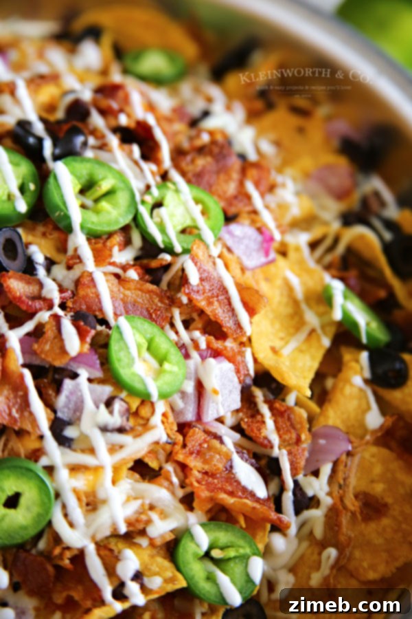 Ultimate Smoked BBQ Bacon Nachos 2 Sheet pan loaded with Smoked BBQ Bacon Nachos before grilling.