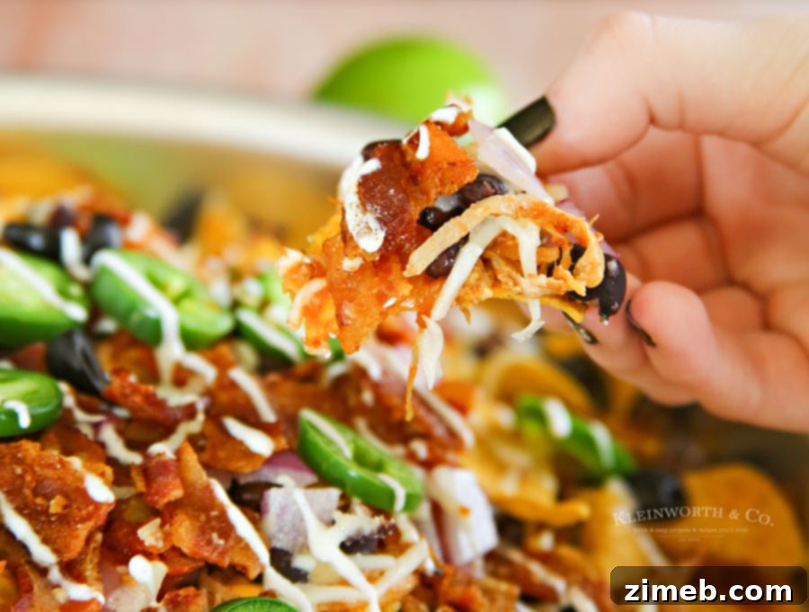 Ultimate Smoked BBQ Bacon Nachos 9 Smoked BBQ Bacon Nachos cooking on the outdoor grill.