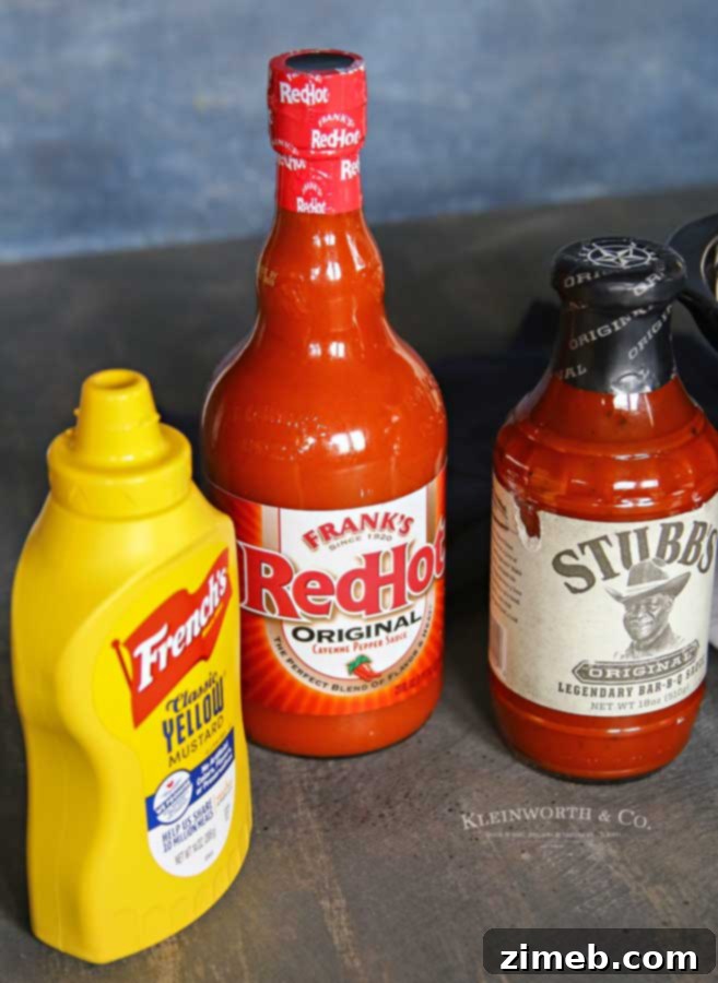 Sticky Sweet and Spicy Slow Cooker Sausage 4 A vibrant display of ingredients for Slow Cooker Sweet & Spicy Sausage, including sausage, various sauces, and grape jelly.