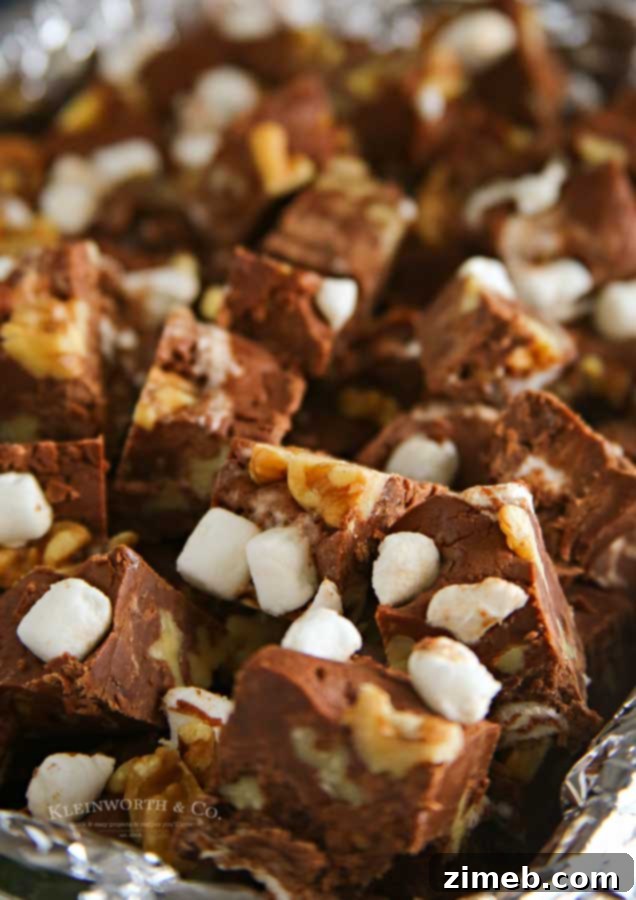 Close-up of freshly cut Rocky Road Fudge squares, showing creamy chocolate, nuts, and marshmallows