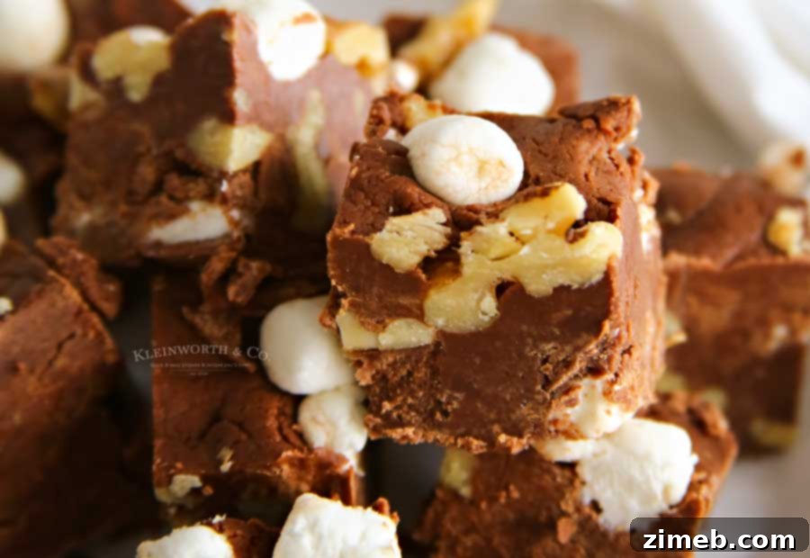 A large slab of the best Rocky Road Fudge, showcasing its rich texture with visible nuts and marshmallows