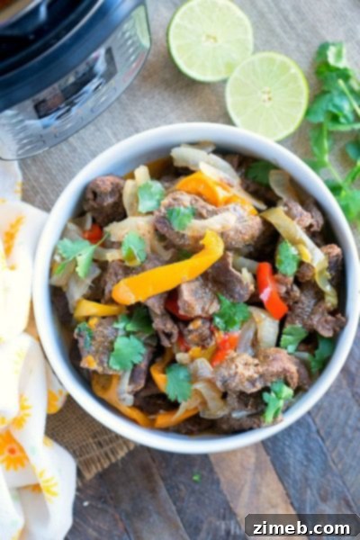 Instant Pot Beef Fajitas – Tender slices of beef with vibrant peppers and onions, perfect for a quick and flavorful Tex-Mex meal.