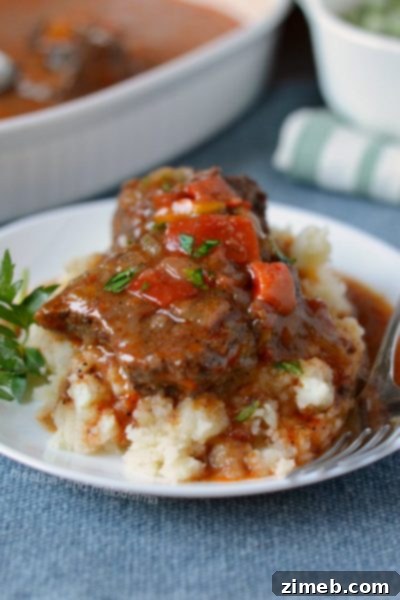 Instant Pot Swiss Steak – Tenderized steak simmered in a rich tomato-based sauce, a classic comfort food made easy.