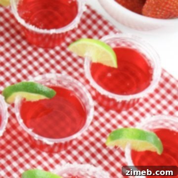 Strawberry margarita Jell-O shot garnished with lime and salt