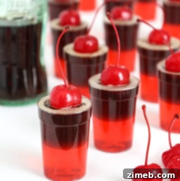 Cherry Cola Jello Shots with a cherry on top