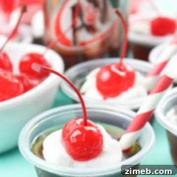 Root Beer Float Jello Shots topped with whipped cream