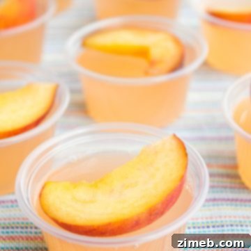 Peach Fizz Jello Shots garnished with peach slices