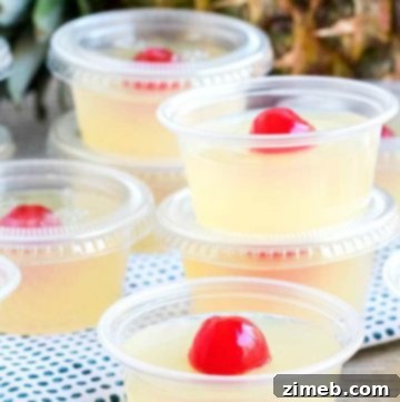 Pina Colada Jello Shots garnished with pineapple