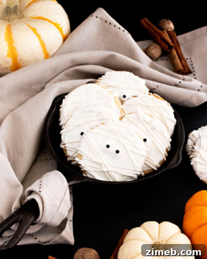Easy Halloween Cookies, showing a plate of decorated mummy cookies